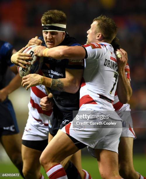 Liam Sutcliffe of Leeds is tackled by Josh Drinkwater of Leigh during the Betfred Super League match between Leigh Centurions and Leeds Rhinos at...