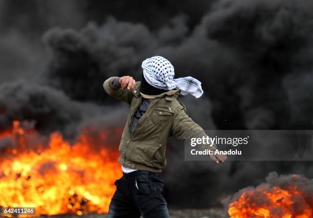 Protesters burn tyres as a response to the Israeli security forces' intervention with plastic bullets and tear gas to a protest against the...