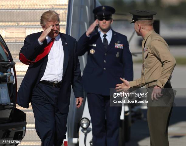 President Donald Trump is greeted as he arrives on Air Force One at the Palm Beach International Airport to spend part of the weekend at Mar-a-Lago...