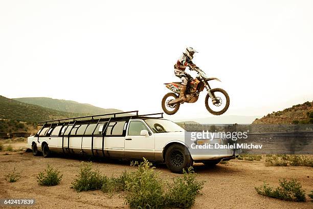 man jumping off limousine with dirt bike. - motocross stock pictures, royalty-free photos & images