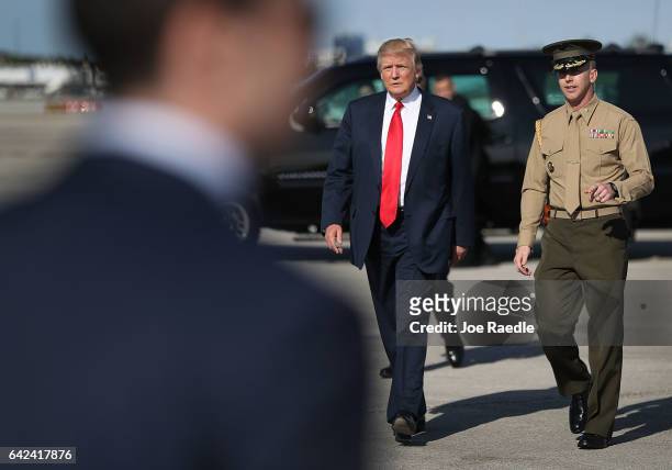 President Donald Trump walks to greet supporters after arriving on Air Force One at the Palm Beach International Airport to spend part of the weekend...