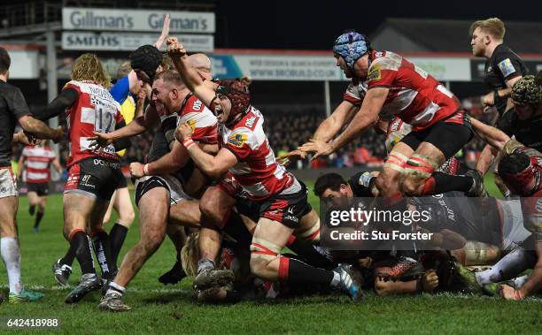 Richard Hibbard of Gloucester goes over to score as his Gloucester team mates celebrate during the Aviva Premiership match between Gloucester Rugby...