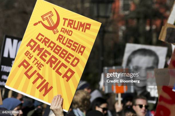 Demonstrator holds a sign during the Solidarity Rally for the General Strike in New York, U.S., on Friday, Feb. 17, 2017. Workers and students...