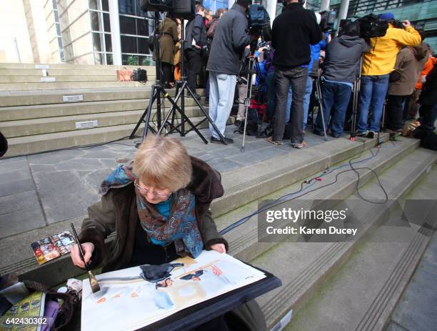 Artist Lois Filber from Seattle paints a scene from inside the hearing while sitting outside the courthouse where U.S. District Court for the Western...