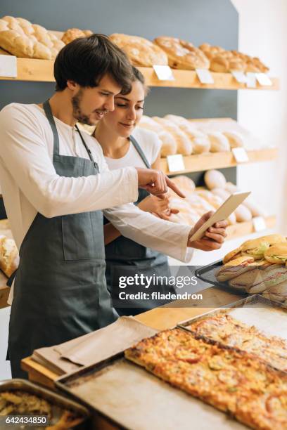bakers using a tablet - ipad kiosk stock pictures, royalty-free photos & images