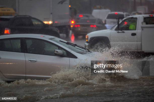 Motorists ford a flooded street as a powerful storm moves across Southern California on February 17, 2017 in Sun Valley, California. After years of...