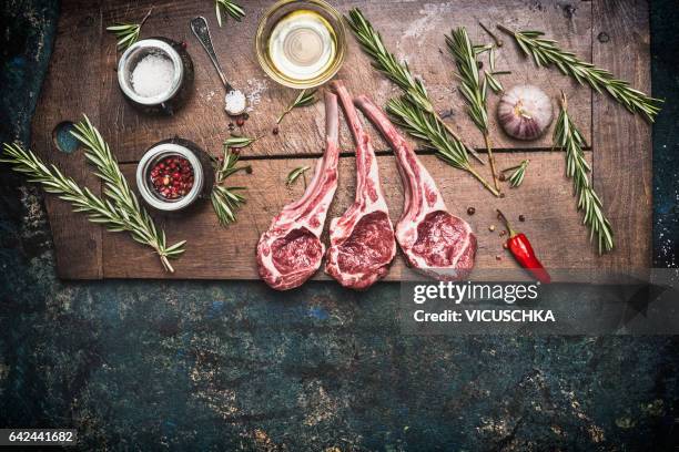 raw lamb chops with cooking ingredients on dark rustic background, top view - lamb ストックフォトと画像
