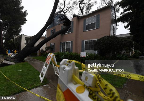 Damaged apartment building after a 75 foot tall tree crashed onto it as the strongest storm in six years slams Los Angeles, California, on February...