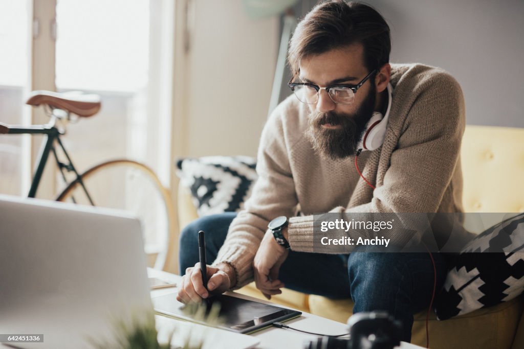 Junge Fotografen im studio tun einige Retusche