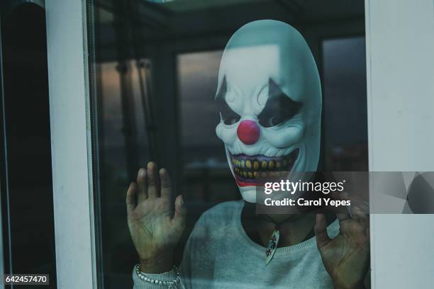 woman with scary clown mask - scary stock pictures, royalty-free photos & images