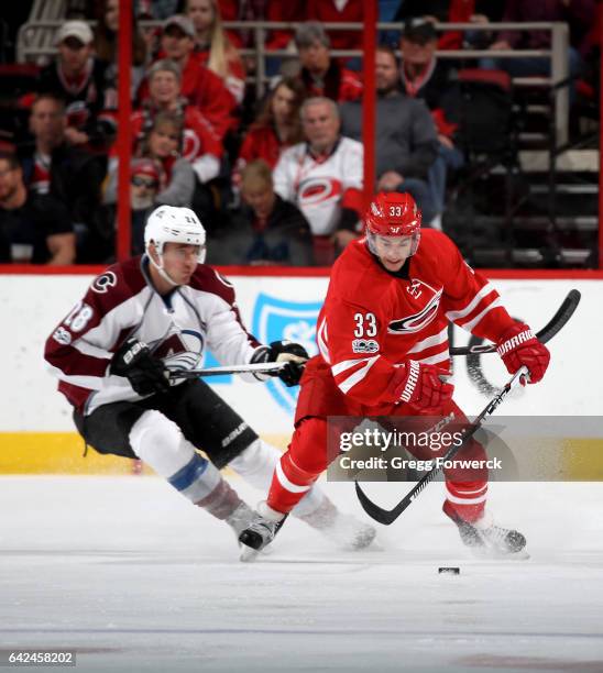 Derek Ryan of the Carolina Hurricanes controls the puck away from Patrick Wiercioch of the Colorado Avalanche during an NHL game on February 17, 2017...