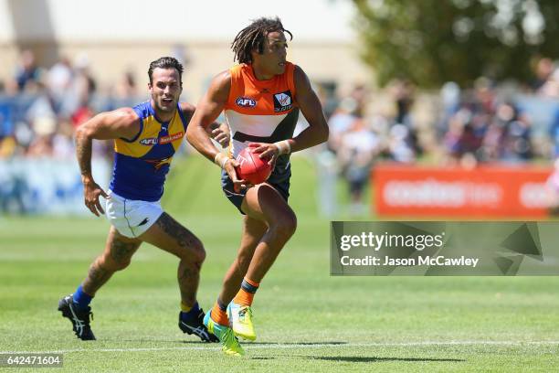 Tendai M'Zungu of the Giants runs the ball during the 2017 JLT Community Series match between Greater Western Sydney Giants and the West Coast Eagles...