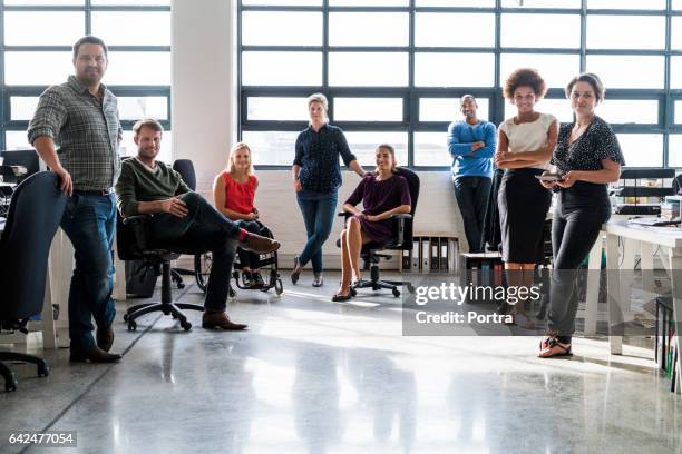 team of business people smiling in creative office - new colleague stock pictures, royalty-free photos & images