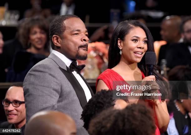 Honoree F. Gary Gray and host Regina Hall speak in the audience during BET Presents the American Black Film Festival Honors on February 17, 2017 in...