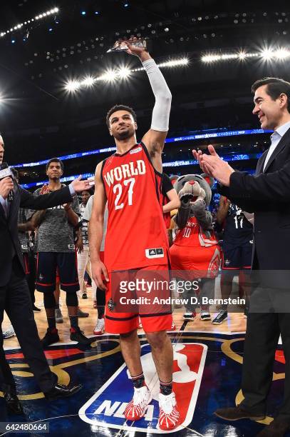 Jamal Murray of the World Team receives the MVP trophy after defeating the USA Team during the BBVA Compass Rising Stars Challenge as part of 2017...