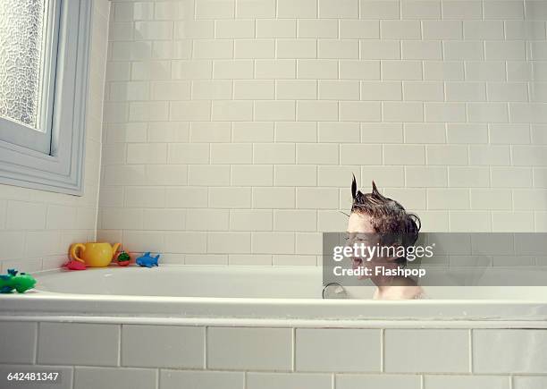 boy enjoying a bath - bad haircut stockfoto's en -beelden