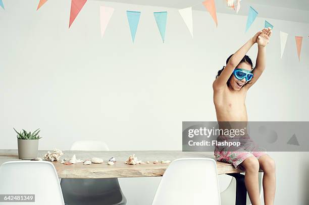 portrait of boy dressed in swim shorts and goggles - three quarter length stock pictures, royalty-free photos & images