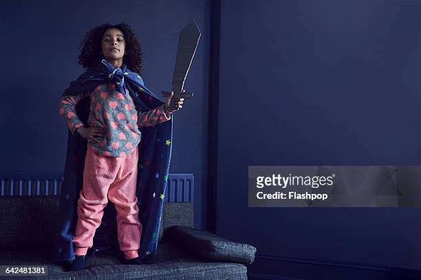 portrait of girl dressed as a superhero - kids imagination stock-fotos und bilder