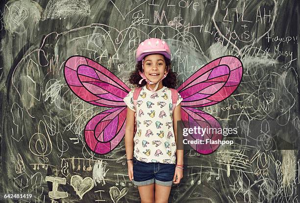 girl smiling with imaginary wings - costume wing stock pictures, royalty-free photos & images