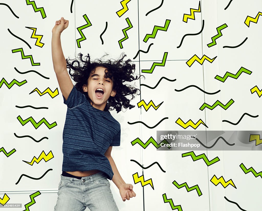 Boy jumping in the air with graphic symbols