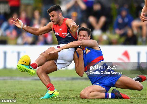 Christian Salem of the Demons kicks whilst being tackled by Lukas Webb of the Bulldogs during the 2017 JLT Community Series match between the Western...