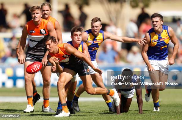 Isaac Cumming of the Giants is tackled by Elliot Yeo of the Eagles during the AFL 2017 JLT Community Series match between the GWS Giants and the West...