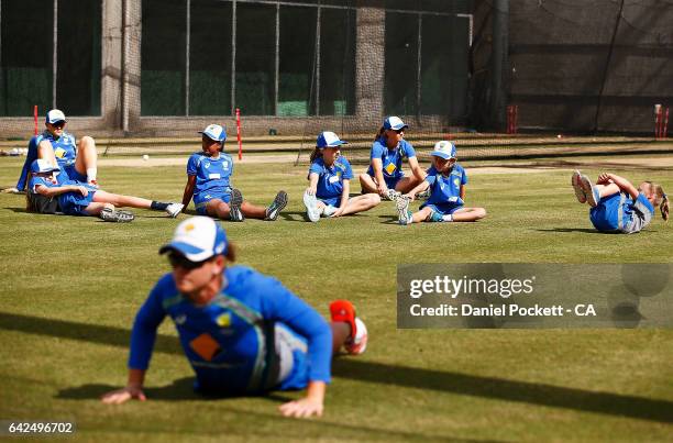 Five young fans participate in warm-ups with the players during a Southern Stars training session at Melbourne Cricket Ground on February 18, 2017 in...