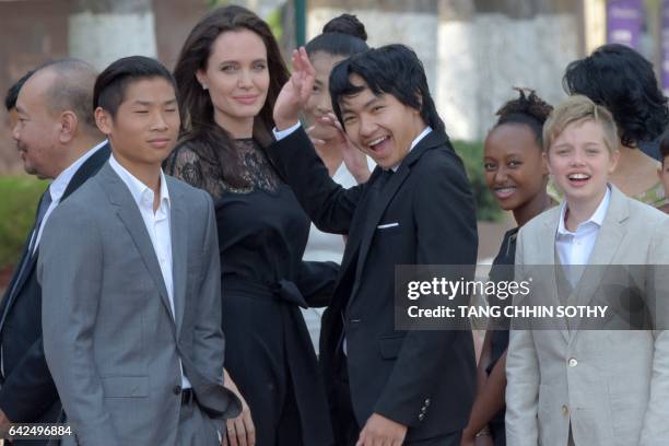 Hollywood star Angelina Jolie and her children including Maddox Jolie-Pitt gesture to media in front of the royal residence for a meeting with...