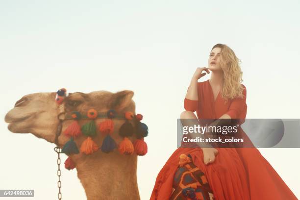 fashion model on camel - hot arabian women stock pictures, royalty-free photos & images