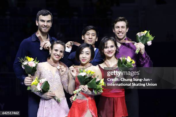 Second place winner Meagan Duhamel and Eric Radford of Canada, first place winner Wenjing Sui and Cong Han of China and third place winner Liubov...