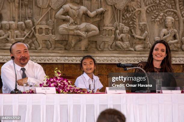 Angelina Jolie laughs with actress Sareum Srey Moch and producer Rithy Panh during a press conference ahead of the premiere of their new movie "First...