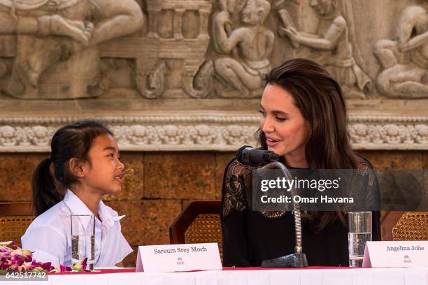 Angelina Jolie talks to actress Sareum Srey Moch during a press conference ahead of the premiere of their new movie "First They Killed My Father" set...