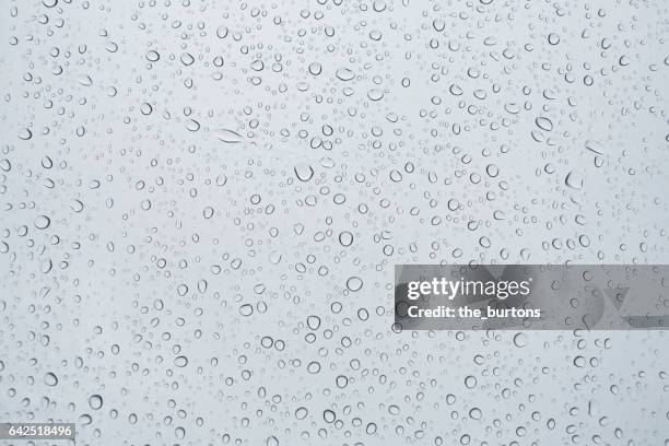 full frame shot of water drops on a window - gotas de agua fotografías e imágenes de stock