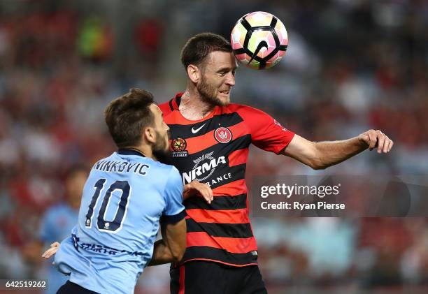 Robbie Cornthwaite of the Wanderers wins the ball over Milos Ninkovic of Sydney FC during the round 20 A-League match between the Western Sydney...