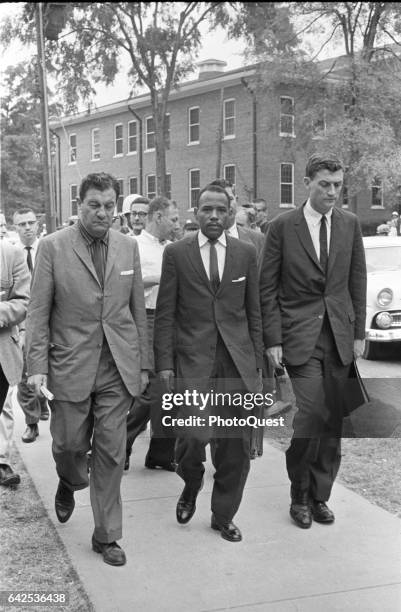 American Civil Rights activist and student James Meredith is escorted by Chief US Marshal James JP McShane and Assistant Attorney General for Civil...