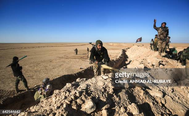 Fighters of the Hashed al-Shaabi paramilitaries prepare defensive positions near the frontline village of Ayn al-Hisan, on the outskirts of Tal Afar...
