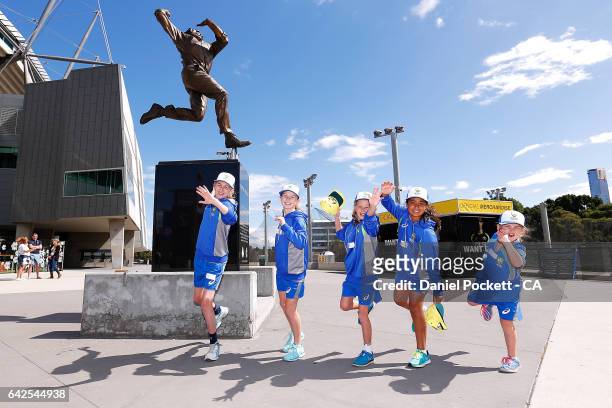 Five young fans imitate Dennis Lillee's bowling action, in front of the Dennis Lillee statue, located outside the MCG during a Southern Stars...