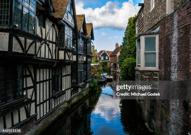 scenic view of buildings lining the river stour in canterbury city center - kent england stock-fotos und bilder