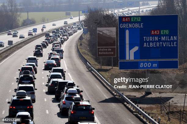 People drive in a holiday traffic jam onto the A43 highway between Chambery and Albertville, in the Tarentaise valley, on February 18, 2017.