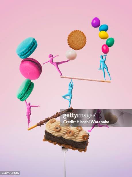 Girls figures taking a balance while exercising with sweets