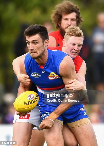 Tom Campbell of the Bulldogs is tackled by Clayton Oliver of the Demons during the 2017 JLT Community Series match between the Western Bulldogs and...
