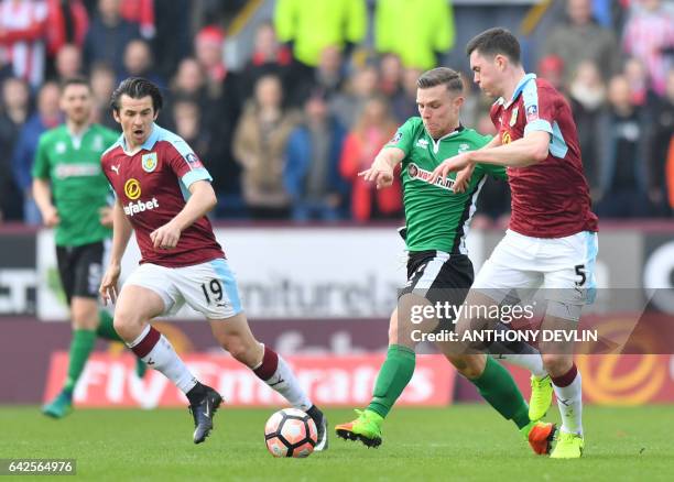 Lincoln City's English striker Jack Muldoon vies with Burnley's English defender Michael Keane during the English FA Cup fifth round football match...