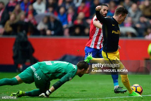Atletico Madrid's French forward Kevin Gameiro shoots to score a goal during the Spanish league football match Real Sporting de Gijon vs Club...