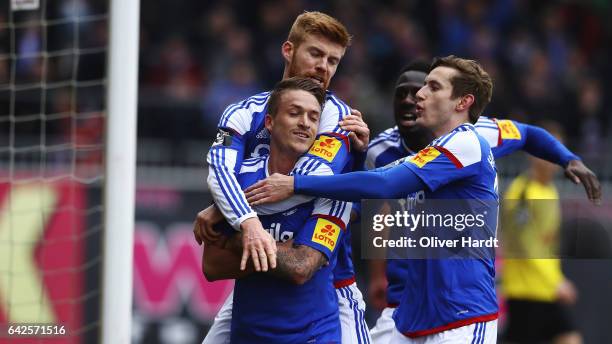 Manuel Janzer of Kiel celebrates with teammates after his team's second goal during the 3 liga match between Holstein Kiel and Fortuna Koeln at...