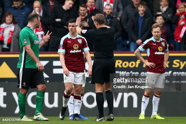 Matt Rhead of Lincoln City and Joey Barton of Burnley exchange words during The Emirates FA Cup Fifth Round match between Burnley and Lincoln City at...