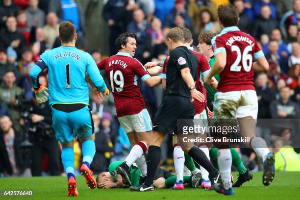Joey Barton of Burnley clashes with the Lincoln City players during The Emirates FA Cup Fifth Round match between Burnley and Lincoln City at Turf...
