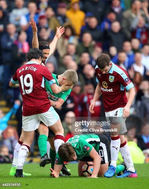 Joey Barton of Burnley and Terry Hawkridge of Lincoln City clash during The Emirates FA Cup Fifth Round match between Burnley and Lincoln City at...