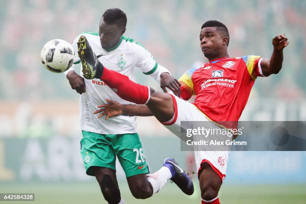 Jhon Cordoba of Mainz is challenged by Ludovic Lamine Sane of Bremen during the Bundesliga match between 1. FSV Mainz 05 and Werder Bremen at Opel...