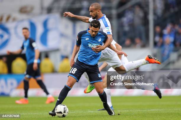 Nadiem Amiri of Hoffenheim is challenged by Terrence Boyd of Darmstadt during the Bundesliga match between TSG 1899 Hoffenheim and SV Darmstadt 98 at...