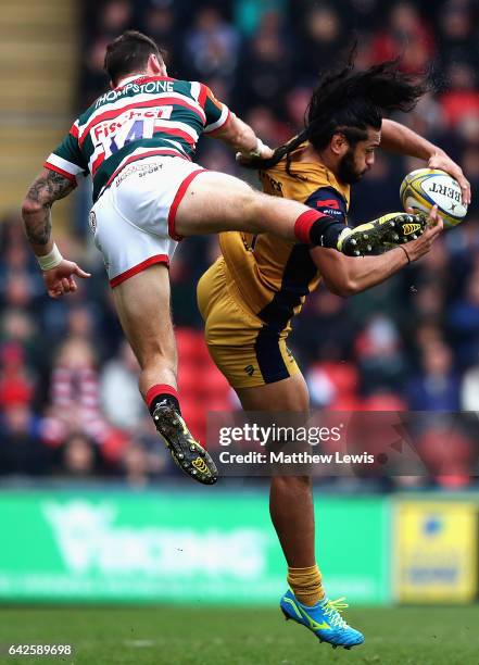 Adam Thompstone of Leicester Tigers and Thretton Palamo of Bristol challenge for the ball during the Aviva Premiership match between Leicester Tigers...